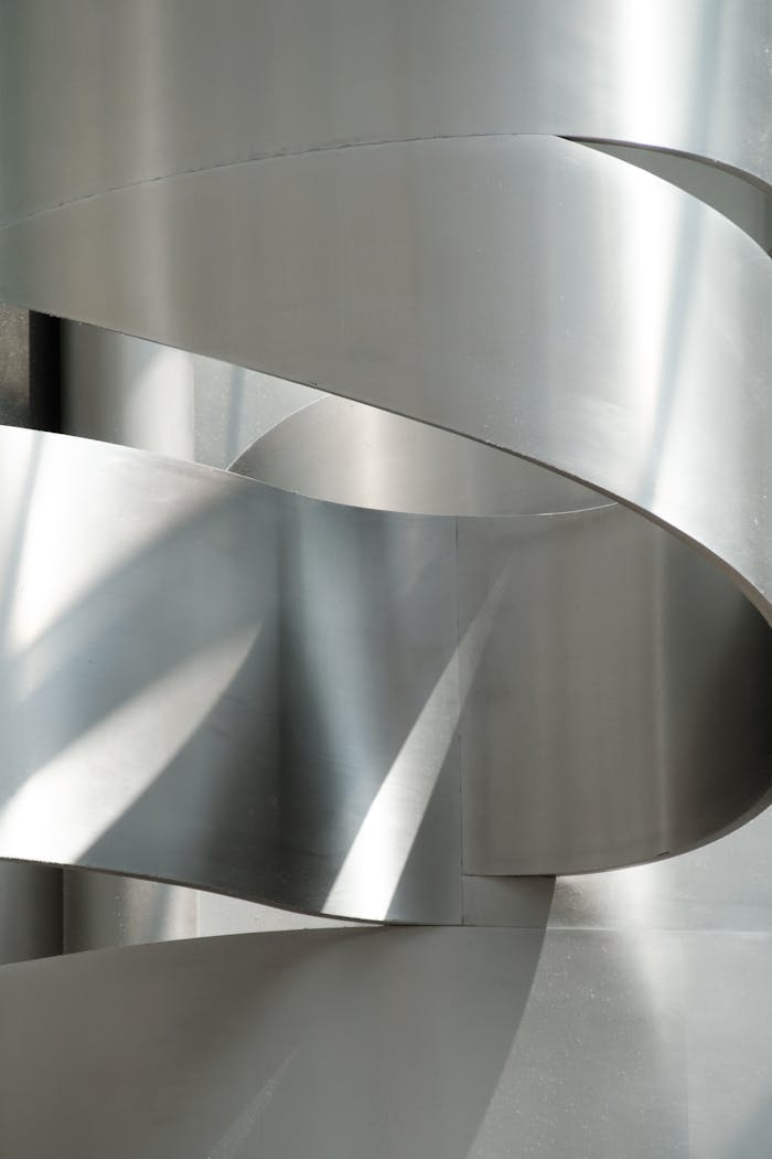 services-02 Abstract composition of intertwined metallic curves with light reflections.